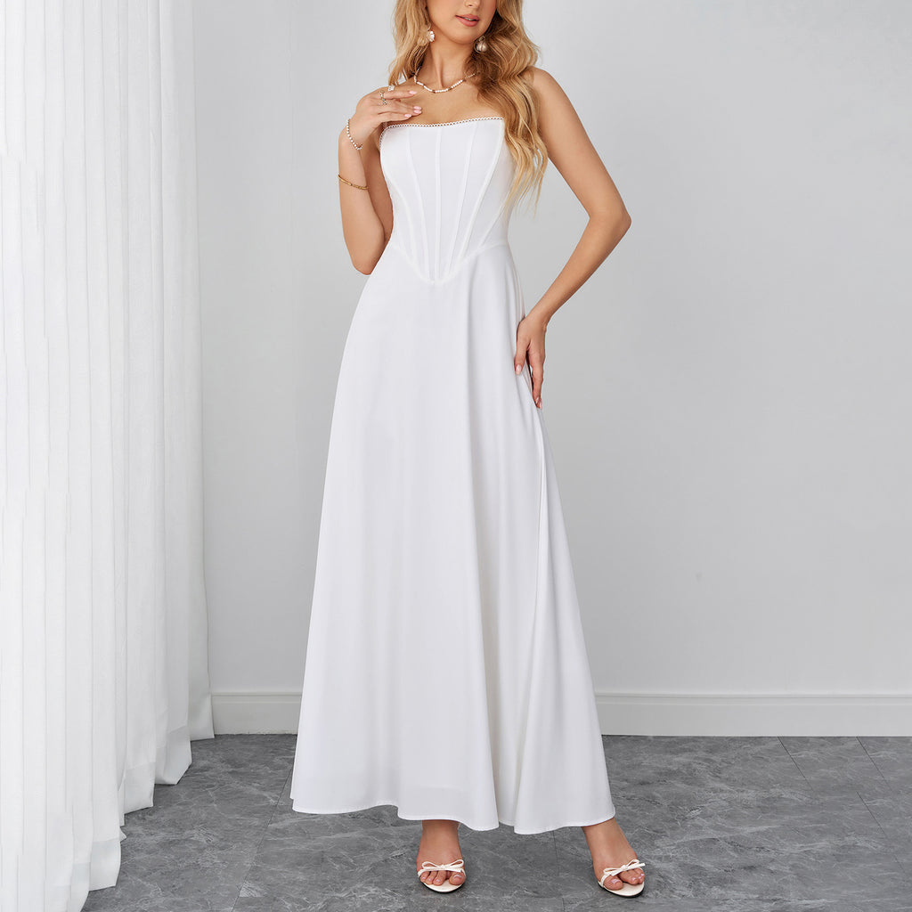 White sleeveless maxi dress with sweetheart neckline and flowing A-line skirt.