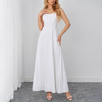 White sleeveless maxi dress with sweetheart neckline and flowing A-line skirt.