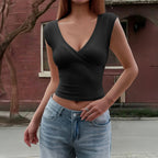 Black wrap V-neck sleeveless vest top with crossed front and fitted waist