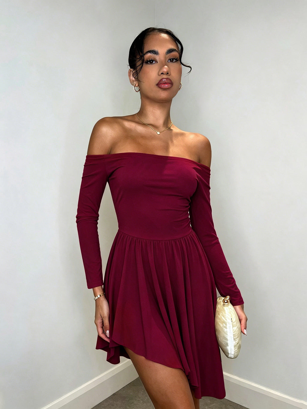 Burgundy off-shoulder long-sleeve mini dress with ruched waist and pleated skirt