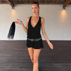 Black sleeveless V-neck dress with cinched waist and flared hem