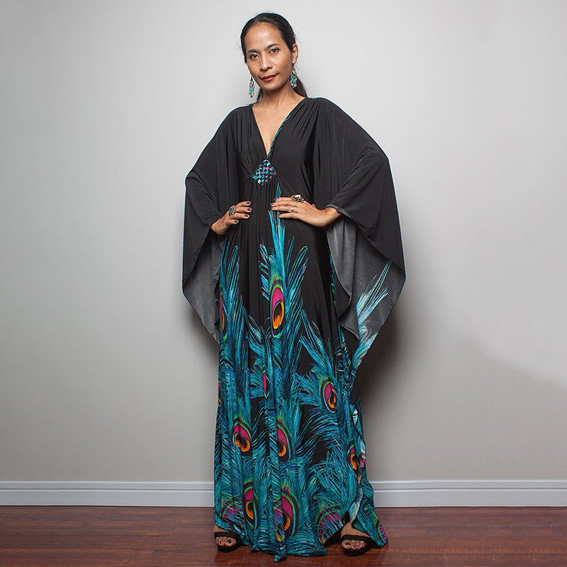 One-piece beach swim dress with V-neck and draped sleeves, featuring peacock feather print