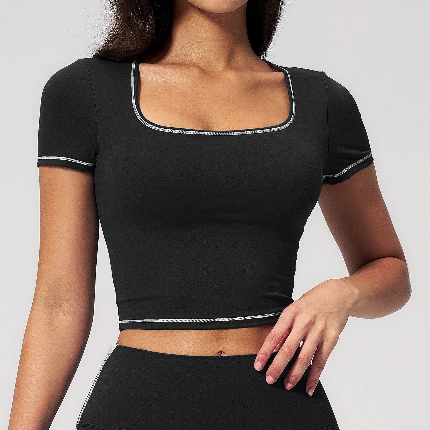 Black cropped sports top with contrast trim at neckline and sleeves