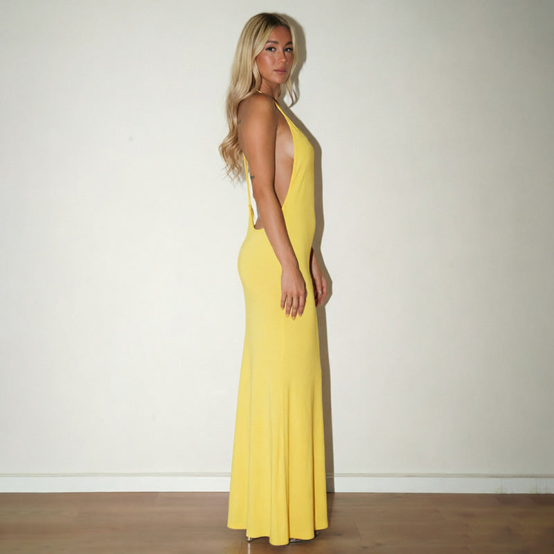 Yellow backless maxi dress with open back and fitted bodice.