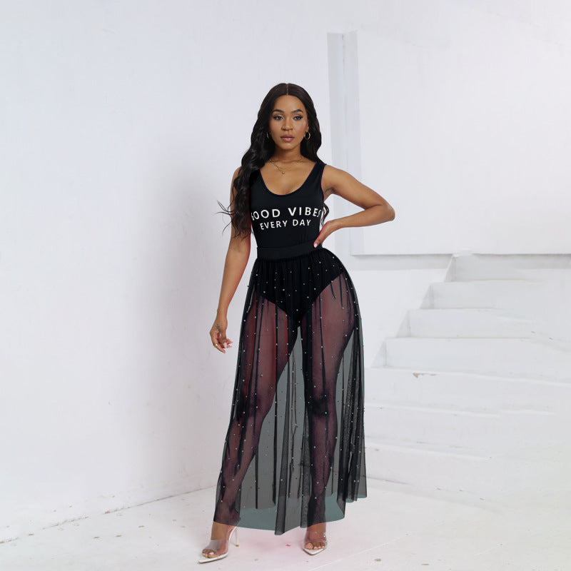 Black sleeveless summer dress with sparkly beaded bust and sheer skirt