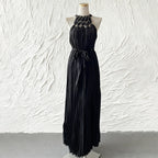 Black sleeveless spring dress with pleated bodice, bow tie waist, long tiered skirt