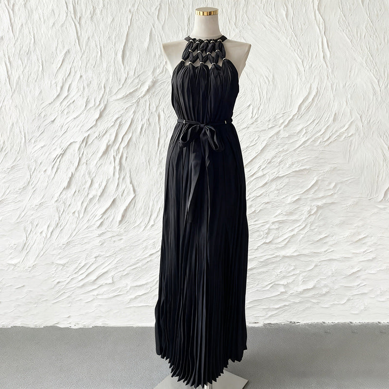 Black sleeveless spring dress with pleated bodice, bow tie waist, long tiered skirt