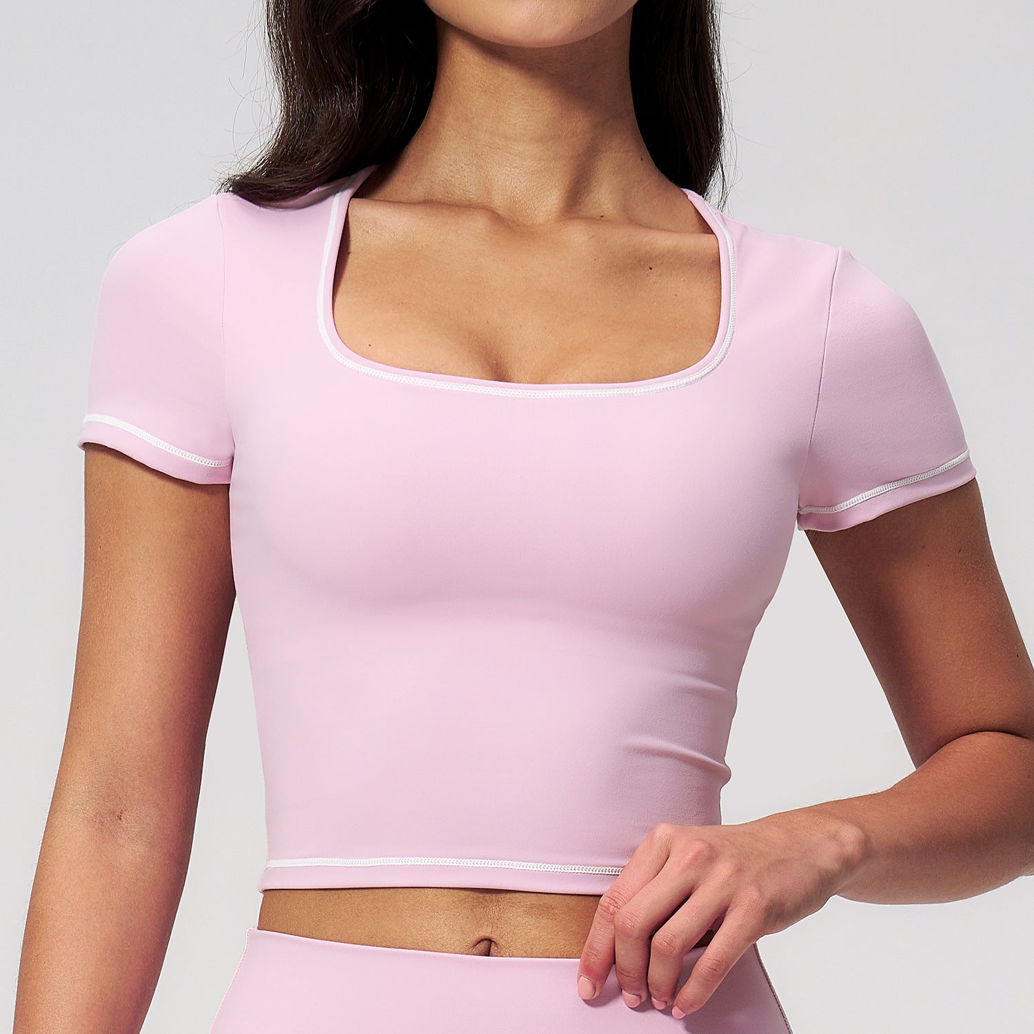 Light pink cropped sports top with contrast neckline and short sleeves