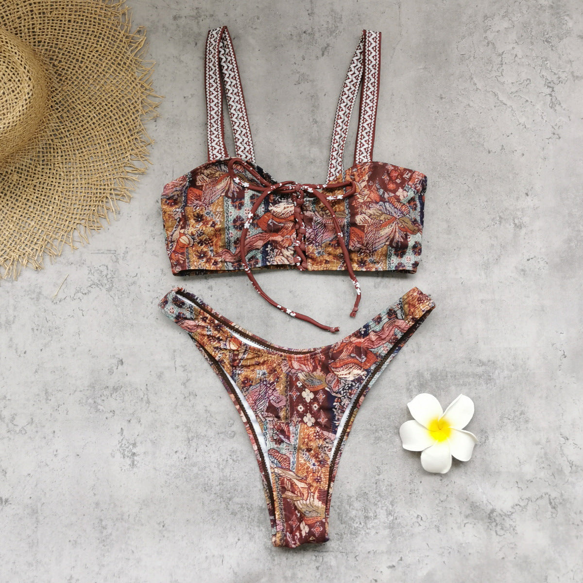Two-piece printed swimwear set with lace-up bralette top and high-cut bottoms; paisley