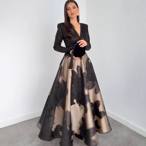 Women's black long-sleeve V-neck maxi dress with abstract tan floral print skirt
