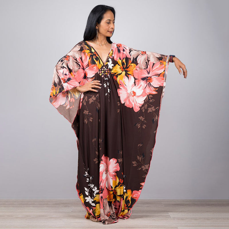 One-piece beach dress in dark brown with pink, orange, and yellow floral print
