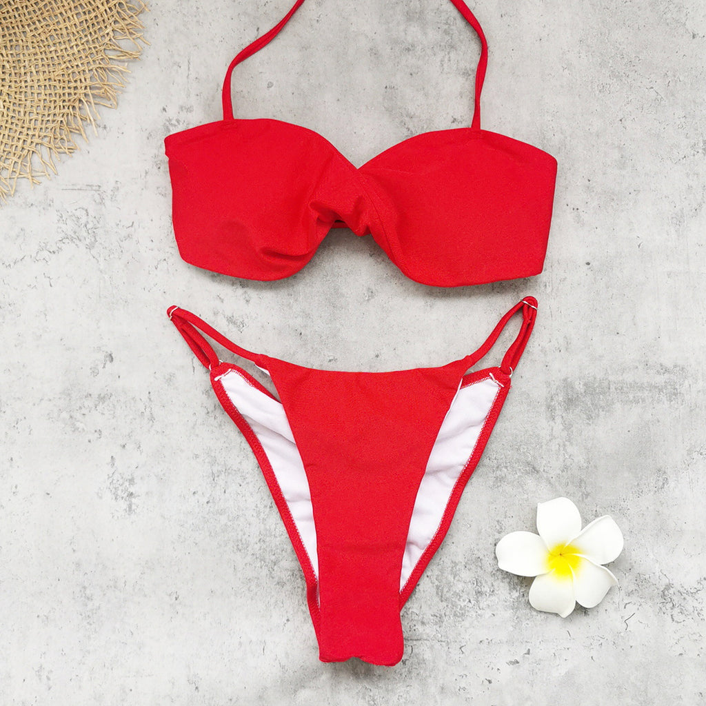 Red bandeau bikini top with matching high-cut bottoms set, flat lay