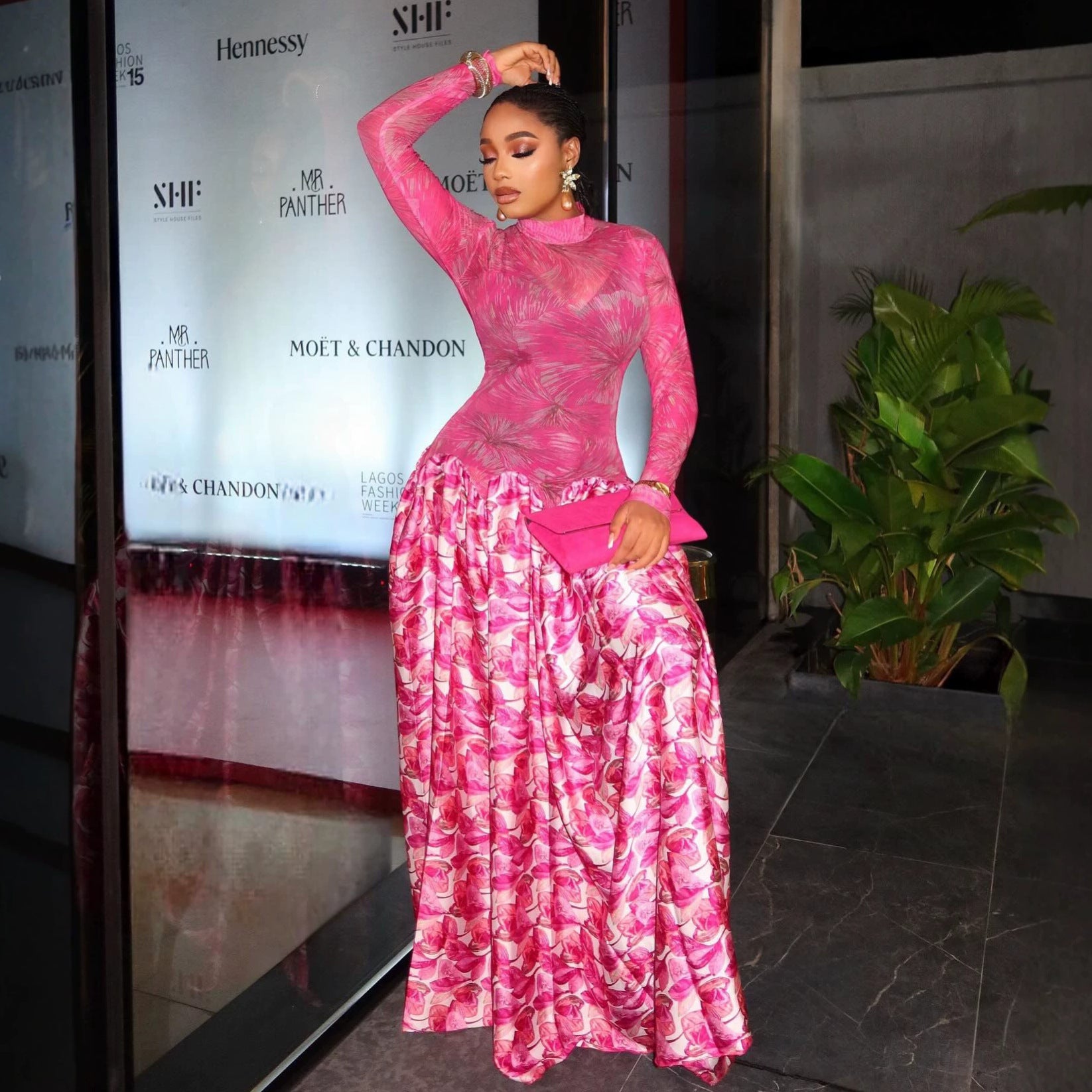 Pink floral long-sleeve maxi dress with high neckline and gathered tiered skirt