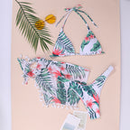 Green leaf and flower print triangle bikini-style one-piece with tassel trim and ties