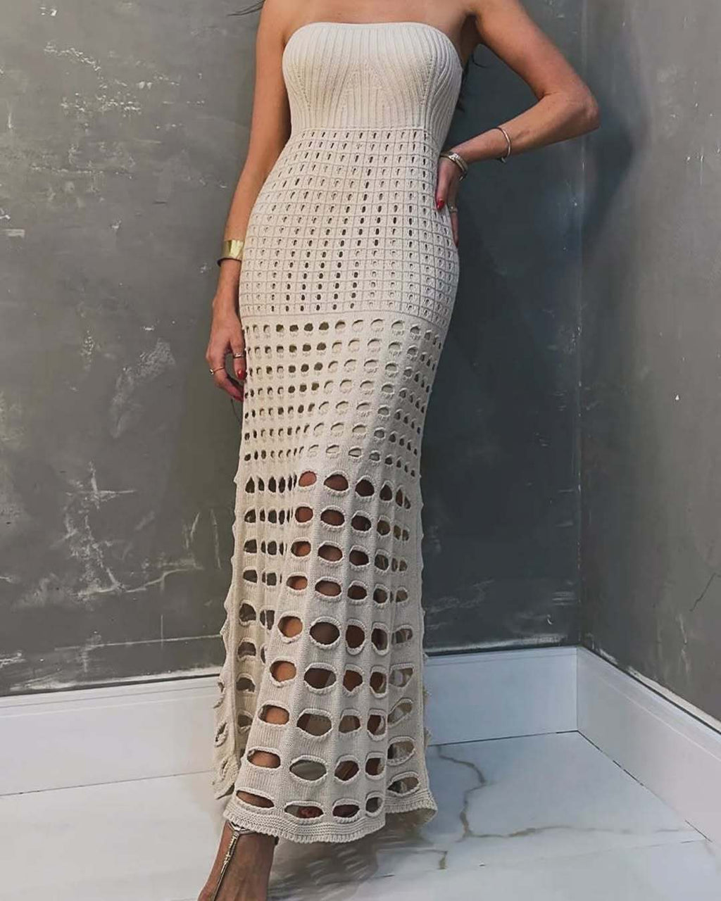 Ivory strapless maxi crochet dress with circular cutout bands and scalloped hem