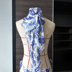 Printed lace bikini set with draped matching headscarf on mannequin, blue-and-white pattern