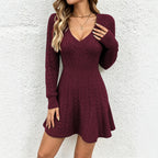 Burgundy knit V-neck dress with long sleeves and cable stitch skirt