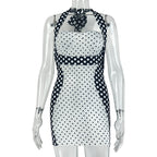Women's halter wrap mini dress on mannequin, black-and-white polka-dot body and halter ties