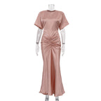 Pink satin sheath dress with crew neckline, short sleeves, ruched waist and long hem
