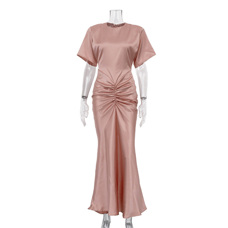 Pink satin sheath dress with crew neckline, short sleeves, ruched waist and long hem