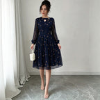 Dark navy chiffon long-sleeve dress with floral print and keyhole neckline, flared skirt