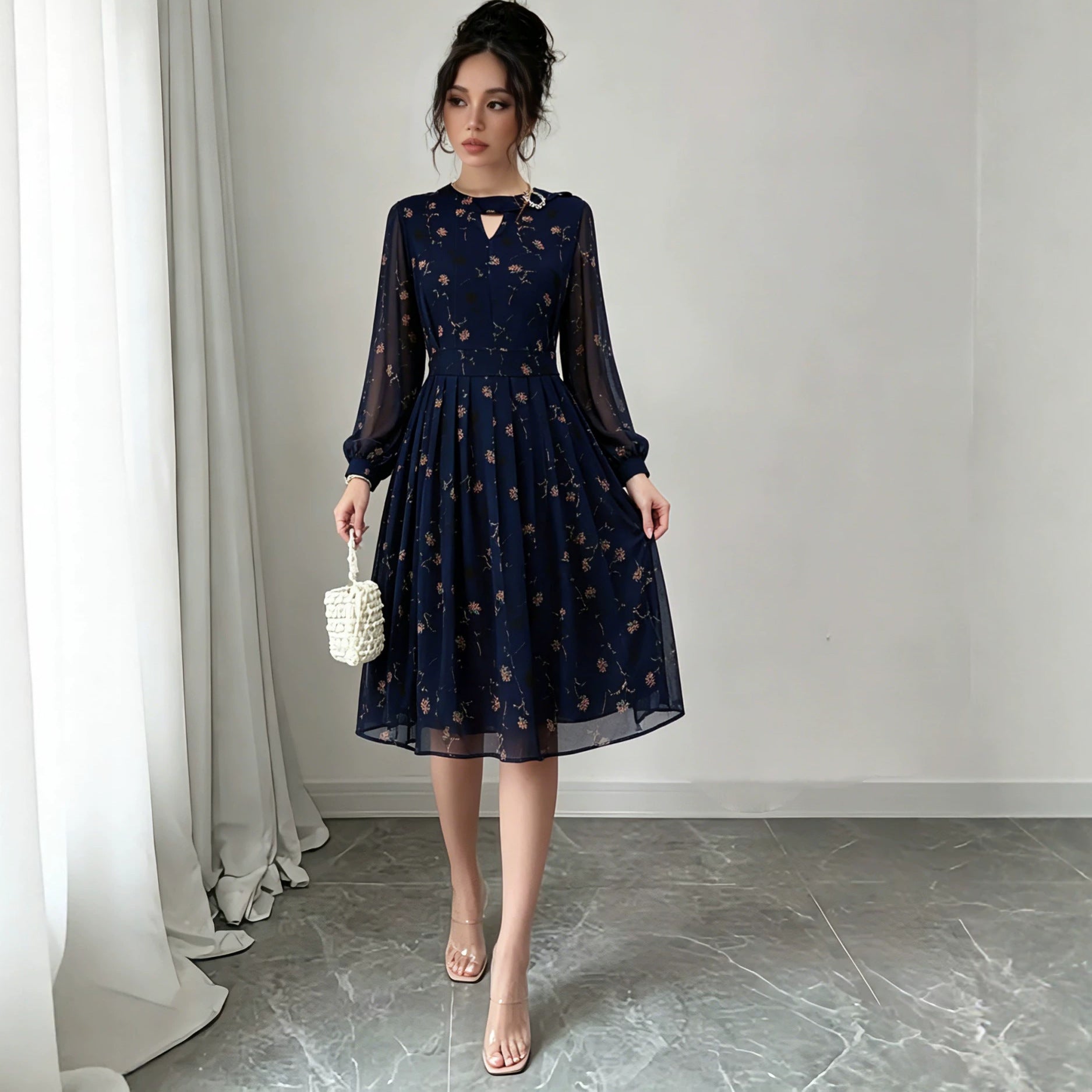 Dark navy chiffon long-sleeve dress with floral print and keyhole neckline, flared skirt
