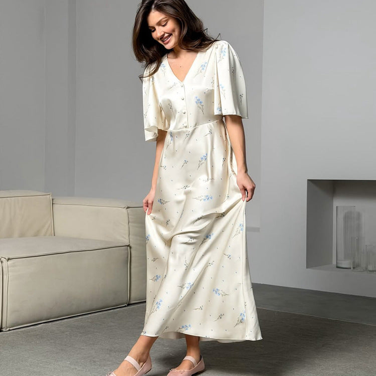 Ivory satin maxi dress with button front, V-neck, blue floral print and waist tie