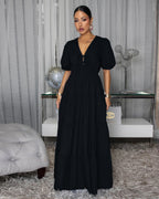 Black tiered maxi dress with puff sleeves and V-neck, gathered waist.