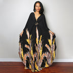Black one-piece swim dress with feather-like floral print and V-neck