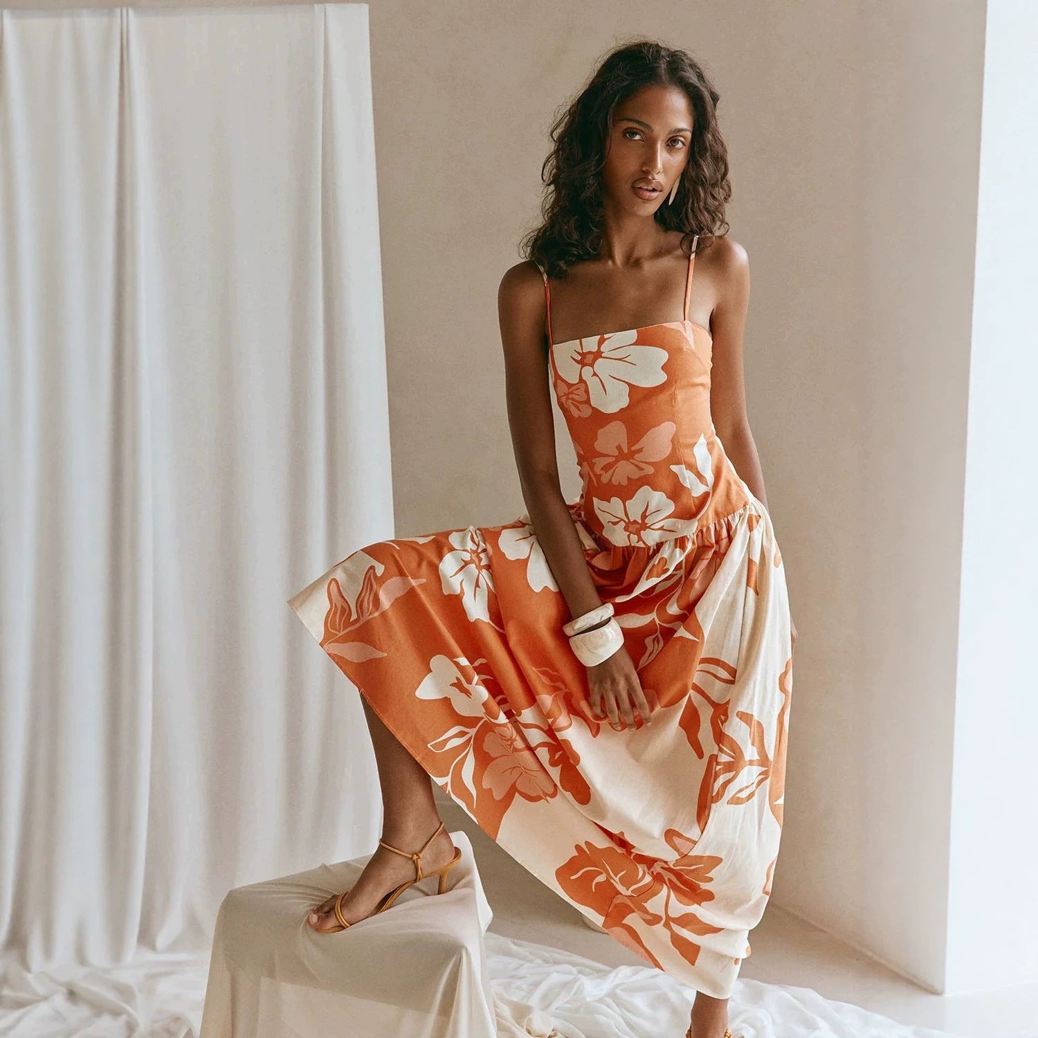 Maxi floral dress in orange and white with spaghetti straps and tiered skirt