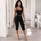 Black spaghetti-strap camisole with waist cutout and slim high-rise capri pants set