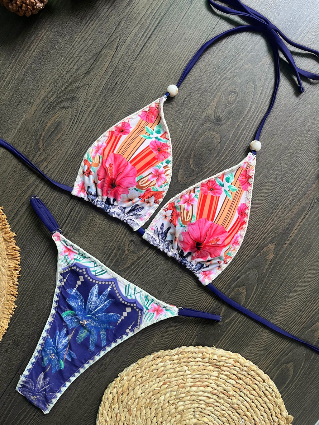 Flat lay of multi-color printed triangle bikini top and side-tie bottoms