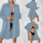 Light blue button-up swim cover-up tunic over black one-piece swimsuit, long sleeves