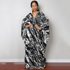 Black and white zebra-striped one-piece swim dress with V-neck and draped sleeves
