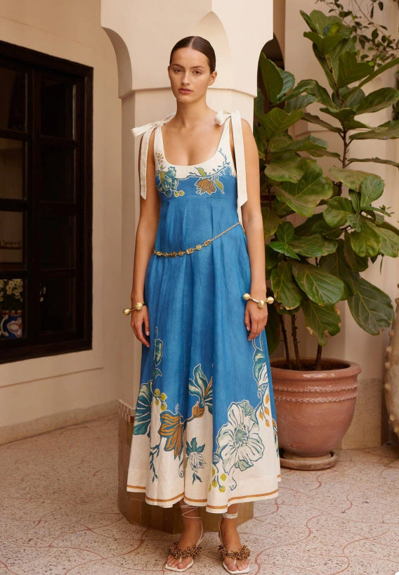 Women's sleeveless blue sundress with floral embroidery, thin straps and tiered hem
