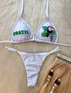 White triangle bikini swimwear with 'BRAZIL' lettering and toucan animal embroidery