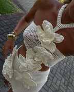Cream halter crochet mini dress with large 3D floral appliques, close-up bodice
