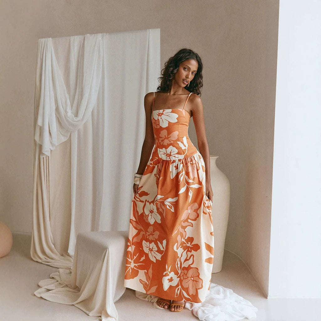 Maxi floral dress in orange and white with spaghetti straps and gathered waist