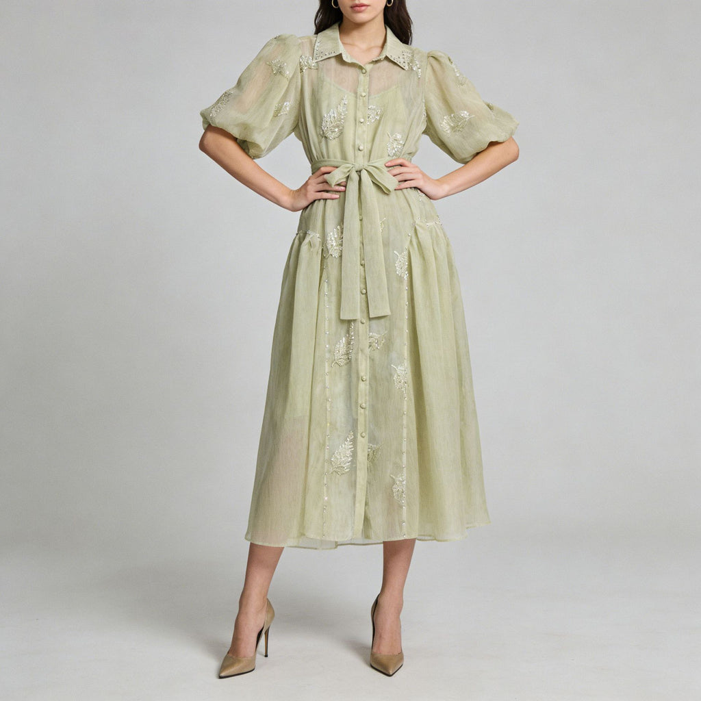 Light green long dress with puff sleeves, button front, and tied waist sash