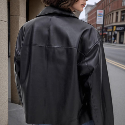 Black leather coat back view with seam details and relaxed fit