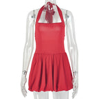 Red halter mini dress with open back, pleated skirt, and halter ties