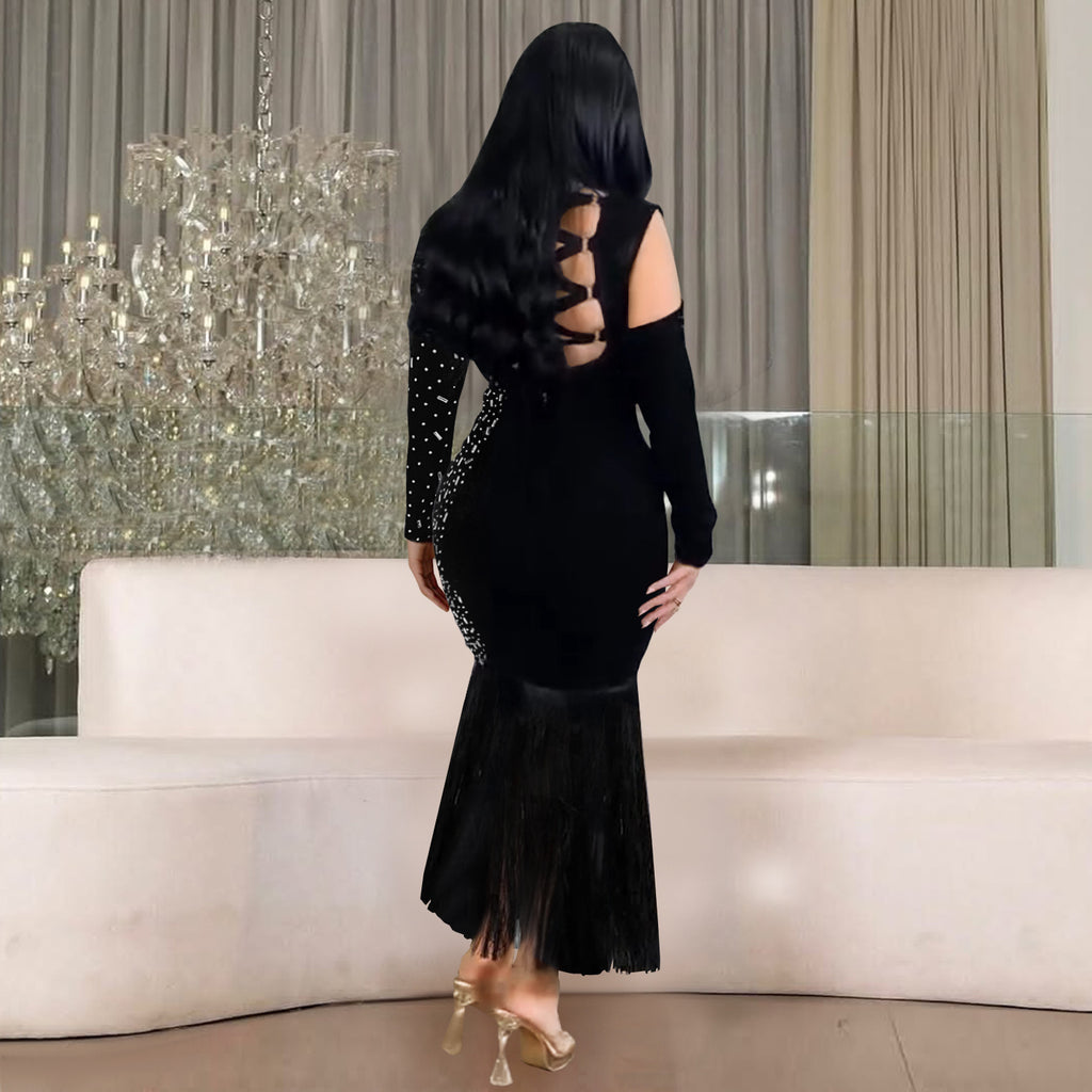 Black long-sleeve dress with open-back cutouts and fringed flare hem