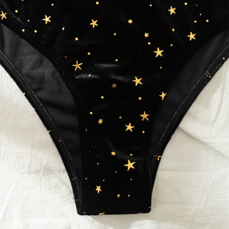 Black high-rise bikini bottoms with gold star pattern and full coverage back