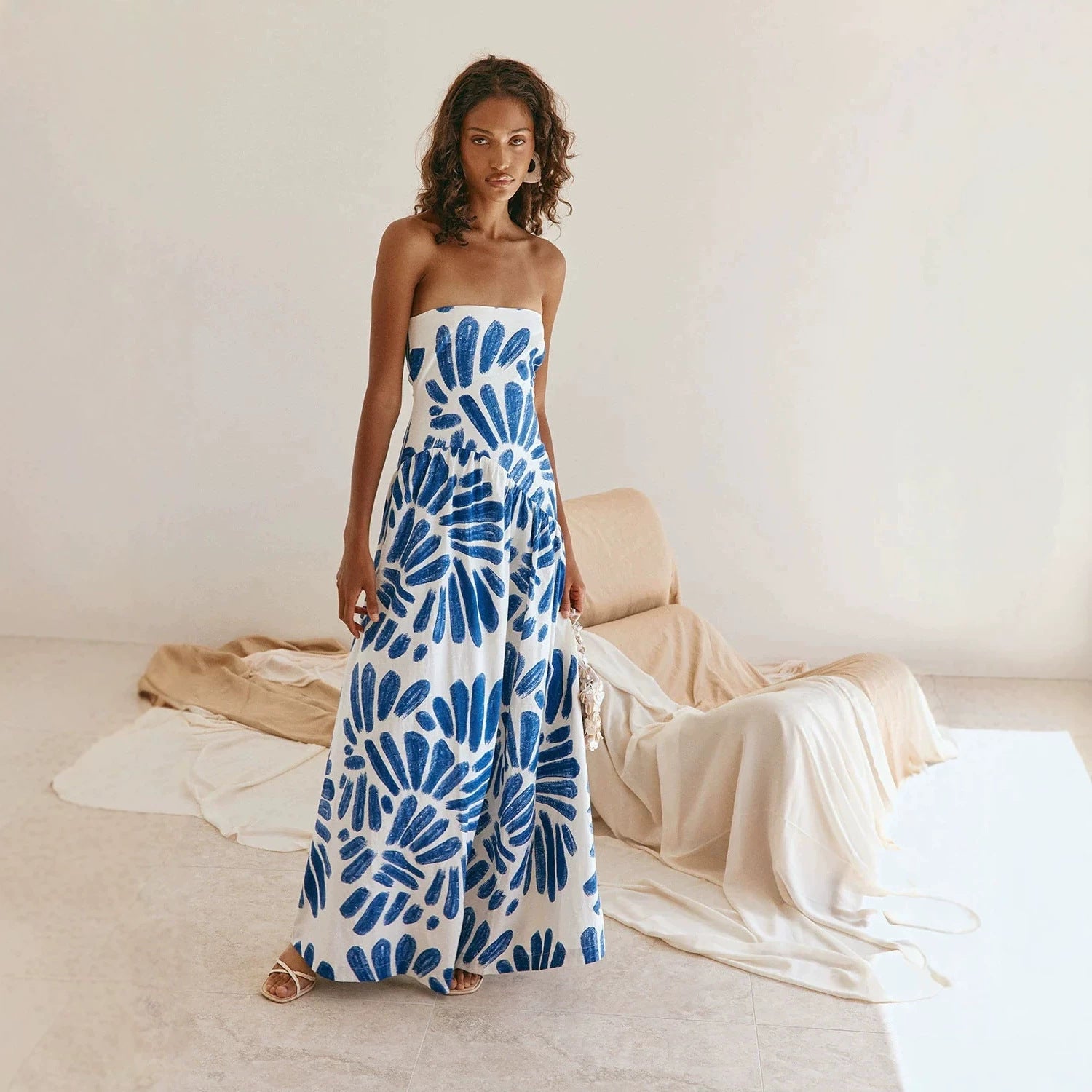 Strapless maxi dress with blue tie-dye floral print, fitted bodice, full skirt