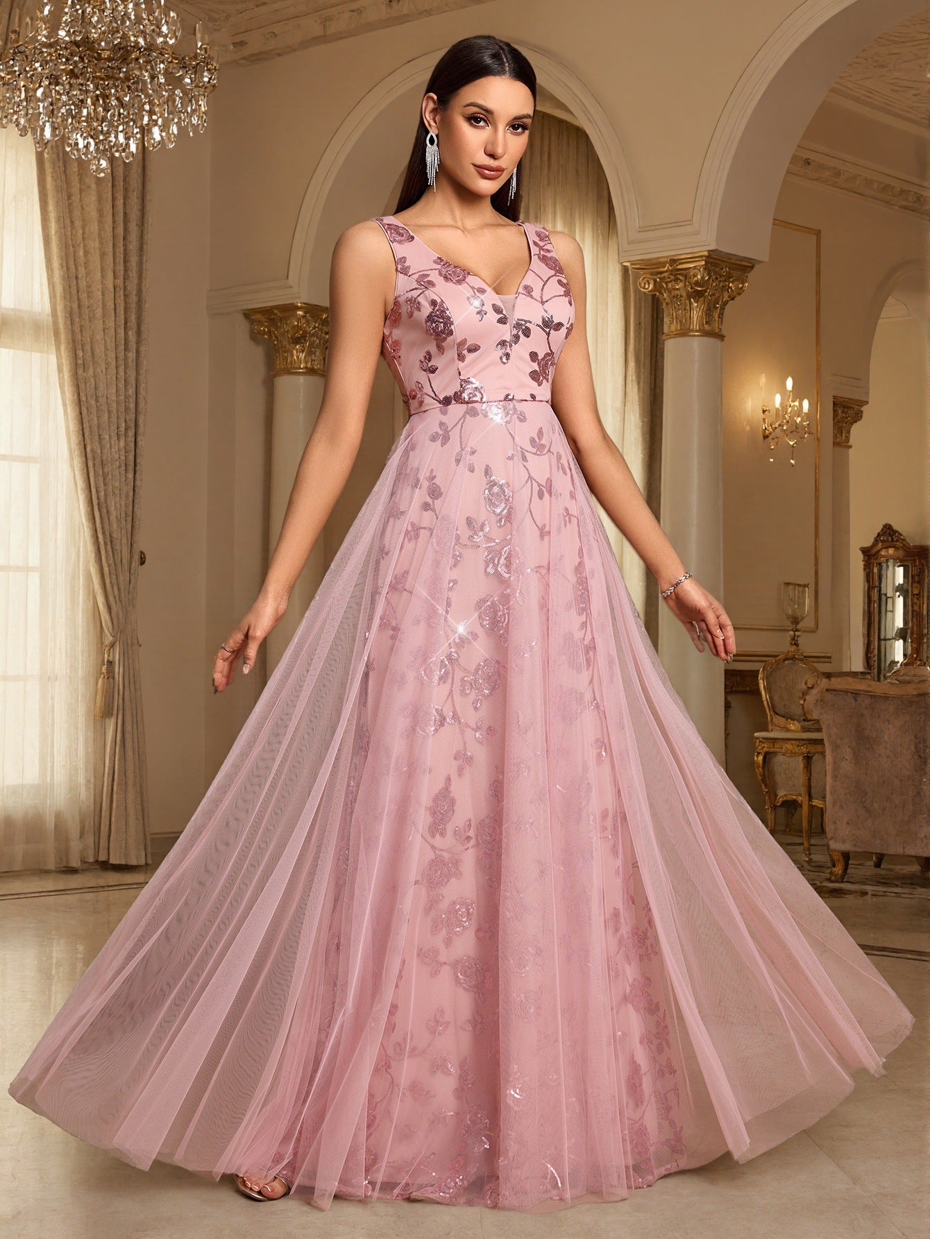 Pink sleeveless sequin evening dress with V-neck, fitted waist, and layered full skirt.