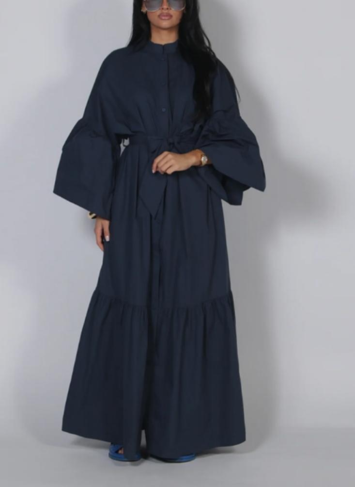 Navy lace long-sleeve dress with draped sleeves, bow waist, and tiered maxi skirt