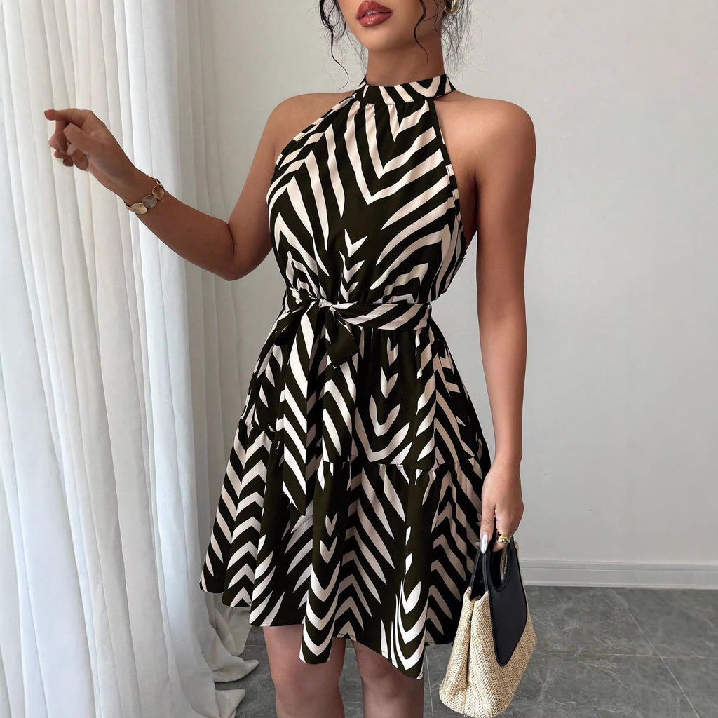 Striped halter dress in black and white with sleeveless halter neckline and tied waist