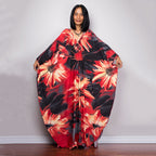 One-piece beach dress with black base and large red-orange flower burst print