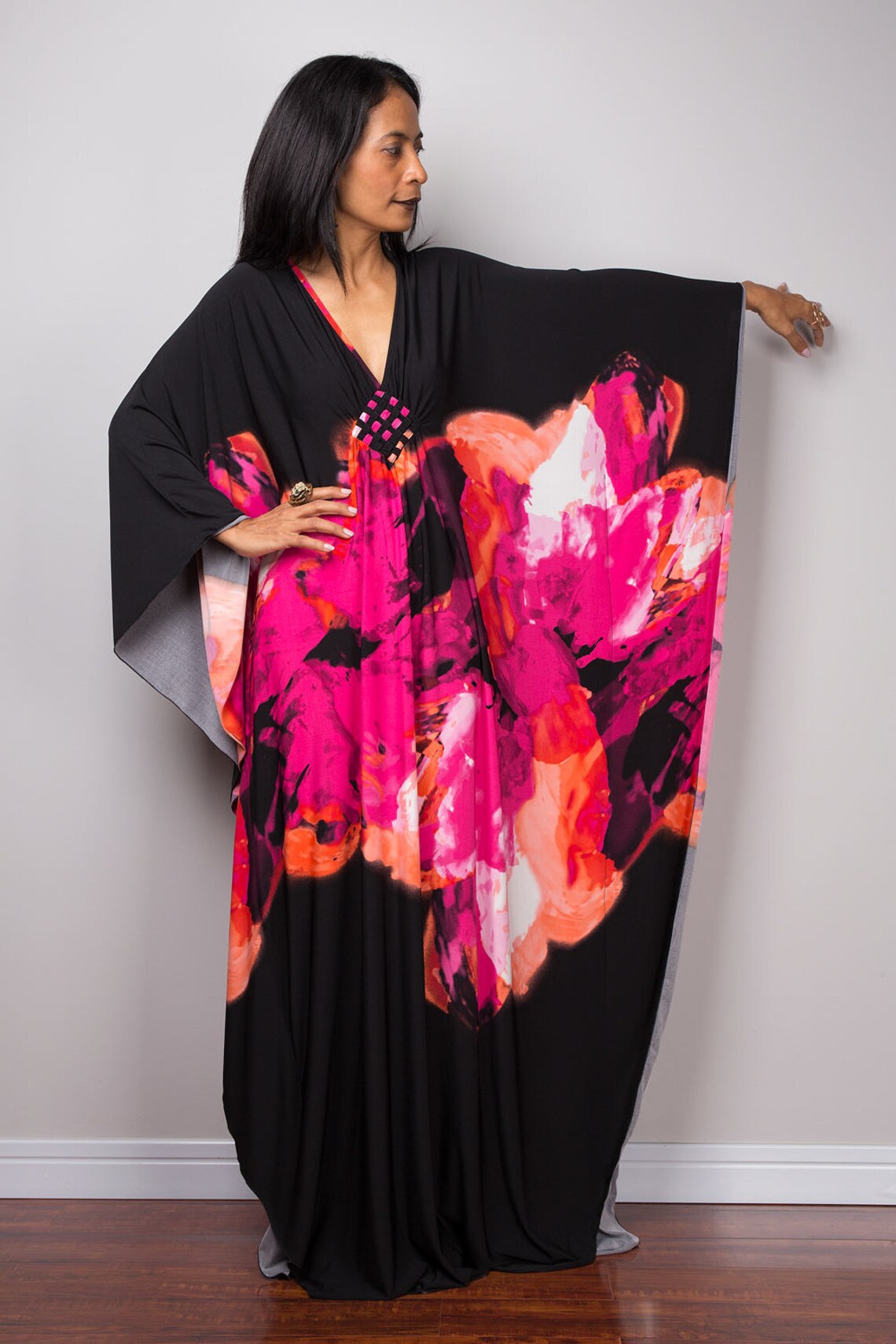 Black beach dress one-piece swimwear with bright pink floral print and flowing sleeves