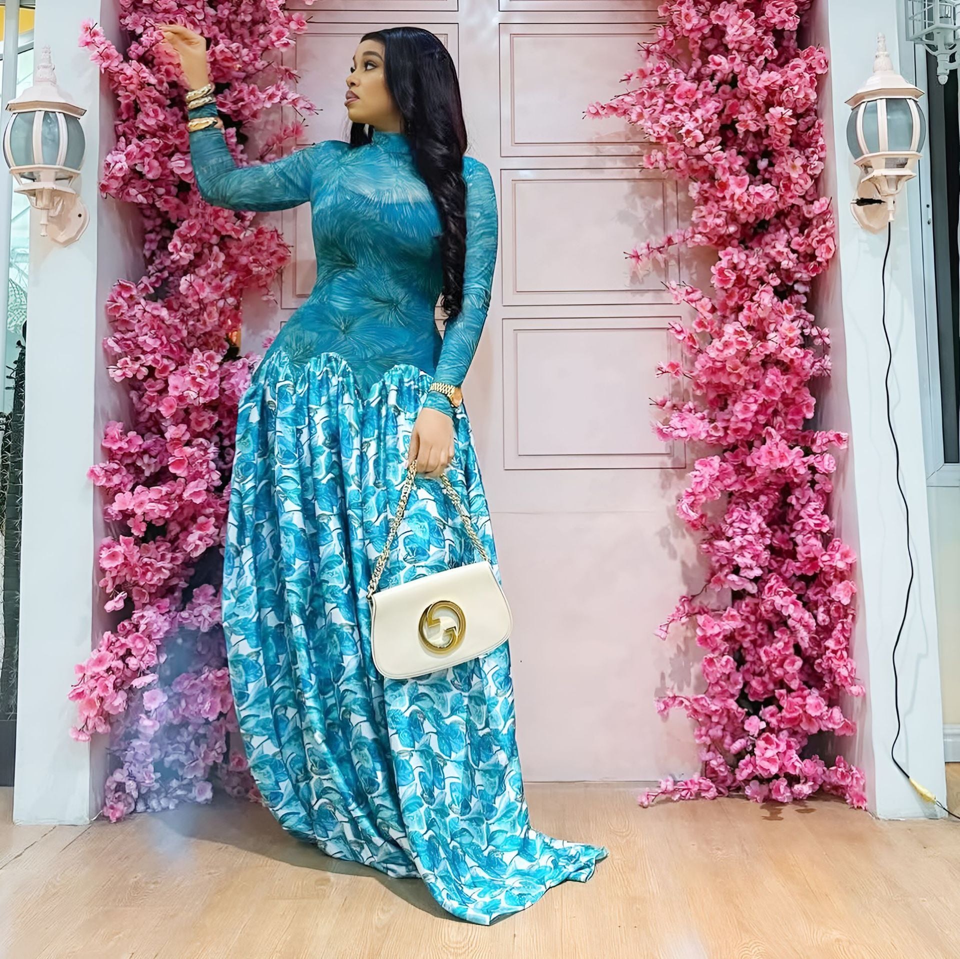 Blue floral long-sleeve maxi dress with high neckline and gathered ruffled skirt hem